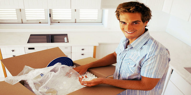 a guy packing delicate items