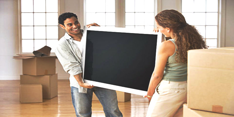 A Couple moving their New TV
