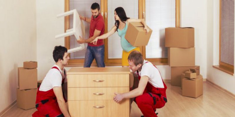 2 removalists and a couple preparing for a move