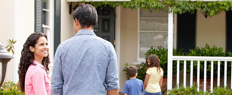 a family inspecting a new house to buy