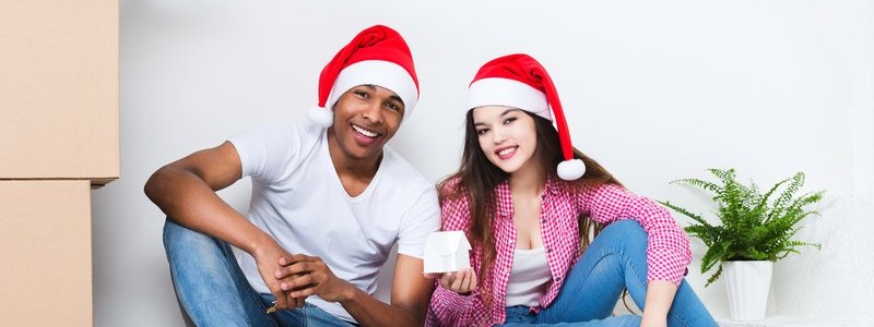 couple wearing Christmas hat preparing for a relocation