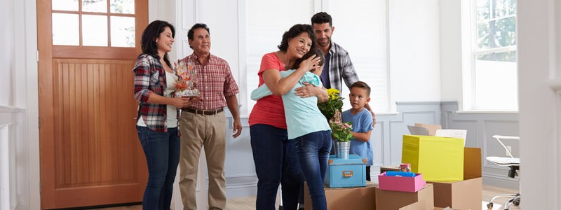 family welcoming guests for housewarming party