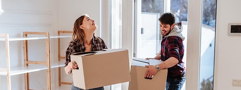young couple inside of their new house