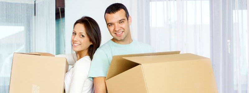 young couple with cardboard boxes preparing to relocate