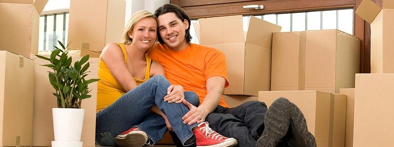 young couple sitting on the floor in their new house