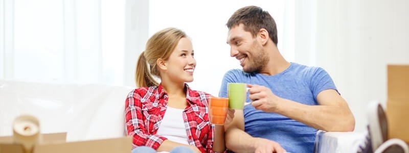 couple sitting relaxed into their new house