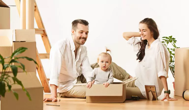 family sitting on the floor of their new house