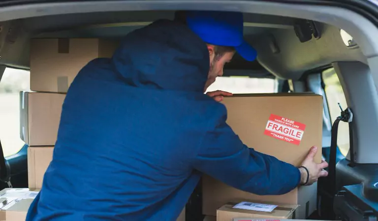 young man loading boxes into a van