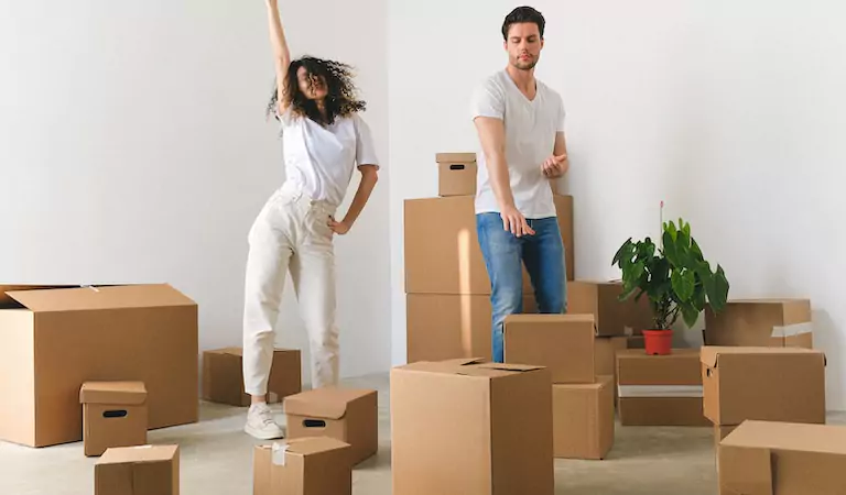 couple inside of their new house with their household