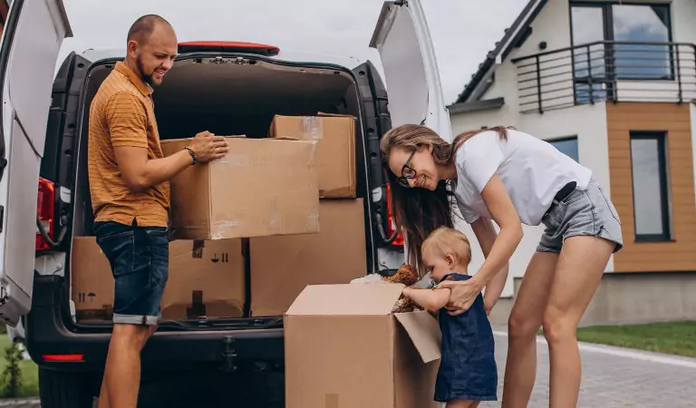 couple loading a van with some boxes
