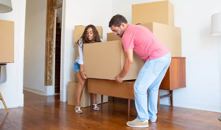couple trying to move a heavy box