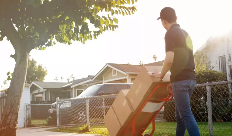 professional mover during a household move pulling a moving trolly