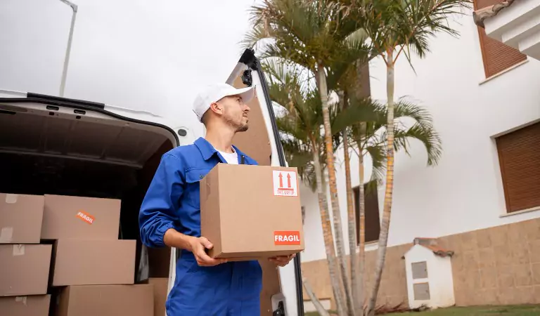 young professional with a cardboard box during a move