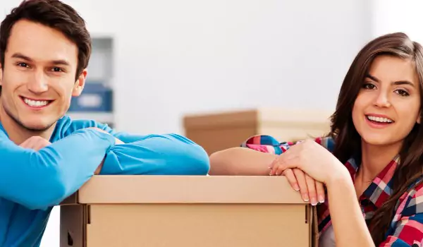 couple with a cardboard box during a house moving