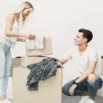 Young man and woman packing boxes